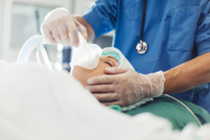 Anesthetic nurses in operation room at hospital with patient