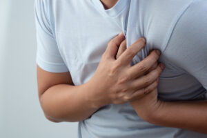 man has a sudden pain in his chest.