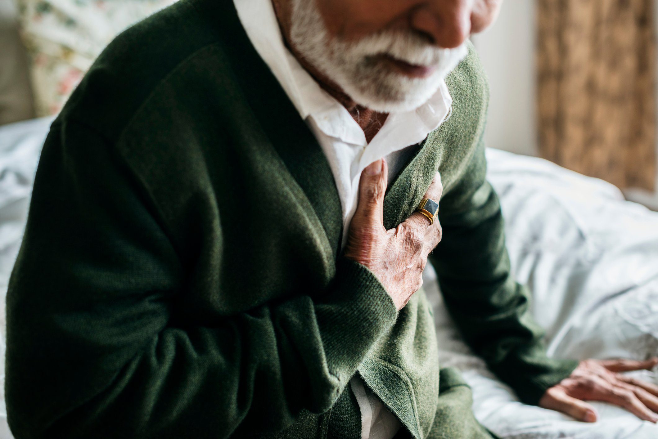 An old man holding his chest in pain an old man holding his chest in pain
