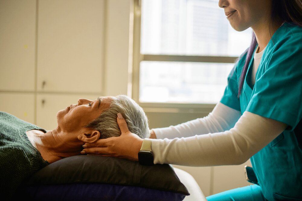 integrative-oncology-massage Therapist gently applying soothing pressure to the scalp during an oncology massage