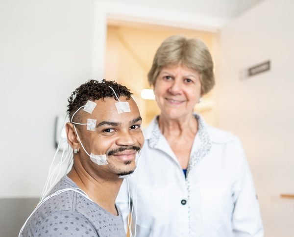 what to expect - Sleep Center - Jamaica Hospital MC Patient undergoing sleep study with electrodes attached to face, chest, and scalp in a clinical sleep lab.